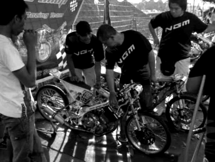 The New Gaya Motor pit crew working on a drag bike trackside