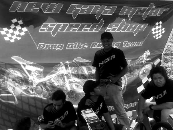 NGM team members in front of the Speed Shop banner